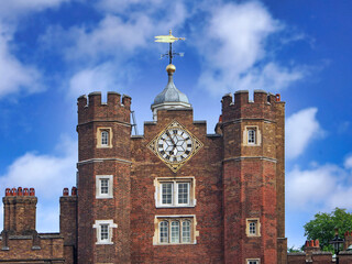 Close-up view of the tower of St. James Palace, with the clock and weather vane
