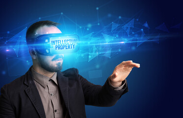 Businessman looking through Virtual Reality glasses, virtual security concept