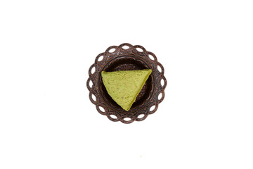 Turkish pistachios halva in metal serving plate isolated on white background, top view