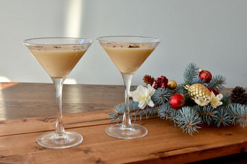 Fancy holiday eggnog and coffee martini drinks ready to serve at home or party, restaurant at Christmas season event. 