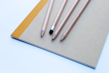 Pencils on notebooks or paper on white background