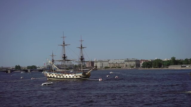 Neva river in city St. Petersburg, panoramic view. Embankment, drawbridge. Birzhevoy bridge. Passenger ships, boats, yachts. Old sailing ship, Navy day.