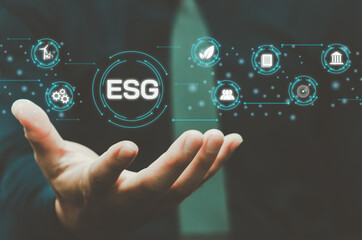Environmental, social, and governance (ESG) investment Organizational growth that is sustainable is a business idea. A man's hand touches the ESG word on a virtual screen.