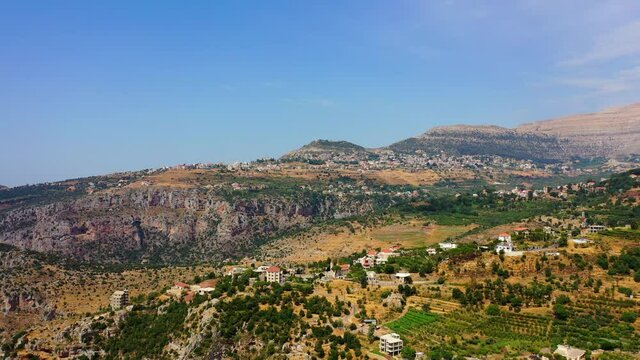 Aerial Forward Beautiful Shot Of Built Houses On Mountains During Sunny Day - Bsharri, Lebanon