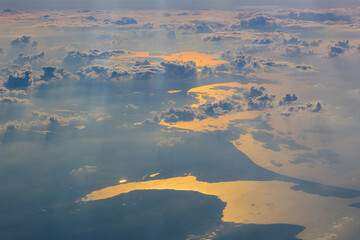 Aerial view of cloudy sunset with ray of lights, approaching Copenhagen, Denmark