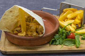 chicken and potatoes with sauce on the plate