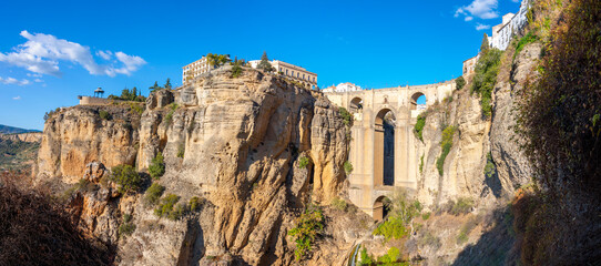 Fototapeta na wymiar Panoramic view of the canyon, old town and bridge in the medieval city of Ronda, Spain, in the Southern Andalusia region.