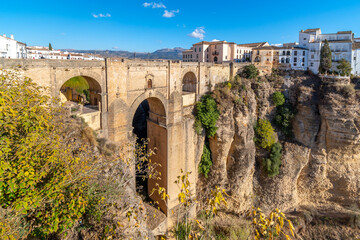 Naklejka na ściany i meble Panoramic view of the canyon, old town and bridge in the medieval city of Ronda, Spain, in the Southern Andalusia region. 