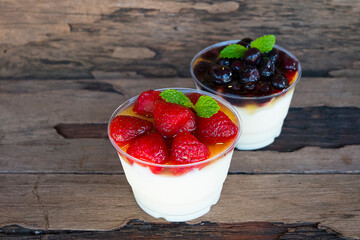 Fruit yogurt has strawberry raspberry blueberry canberry and honey greek white clean In bowl on a wooden background from top view.
