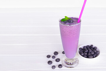 Blueberry Juice smoothies drink in a glass drink purple colorful fruit juice milkshake blend beverage healthy high protein the taste yummy in glass on white wood background.