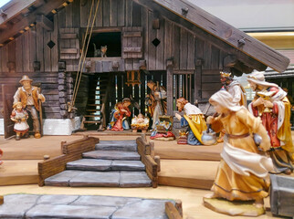 Traditional Christmas nativity scene with beautiful figures made out of wood. The birth of Jesus Christ in the manger surrounded by Joseph, Mary and the Magi.