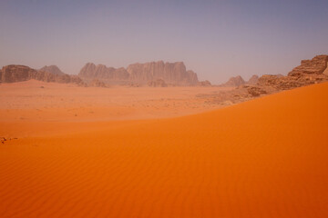 Fototapeta na wymiar Bright orange dunes in Wadi Rum desert, Jordan
