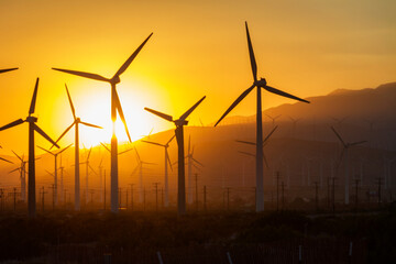 The sun sets over a windmill farm in Palm Springs, California