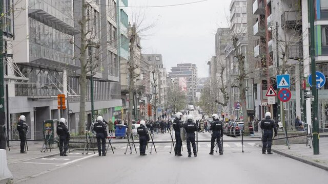 The riot police holding the ground during riots, protests in Brussels, Belgium. Protest in the background