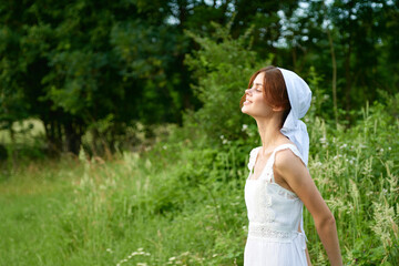 Naklejka na ściany i meble Woman in white dress countryside village nature ecology