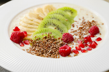 Tasty yoghurt with fruits and flax seeds in bowl, closeup