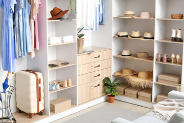 Stylish clothes, shoes and accessories in wardrobe