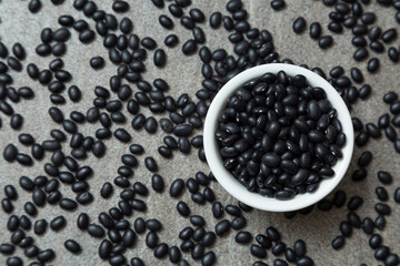 Fototapeta na wymiar a pile of black bean and black bean in white bowl