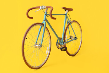 Stylish bicycle on yellow background