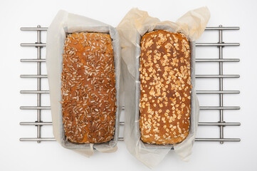 Top view of two loaves of fresh bread on the steel trivet