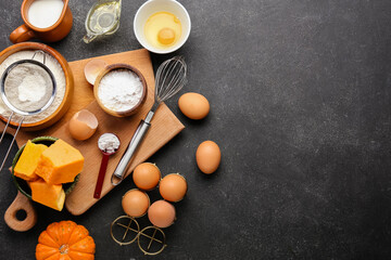 Fresh ingredients for preparing pumpkin pie on black background