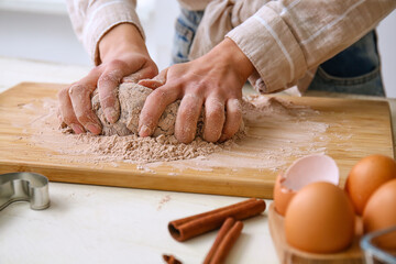 Woman preparing chocolate dough at kitchen table, closeup