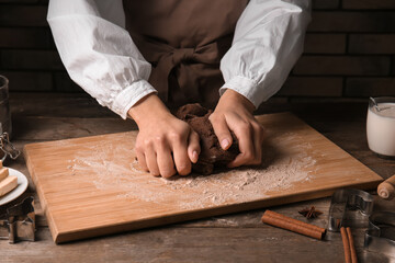 Woman preparing chocolate dough at kitchen table, closeup