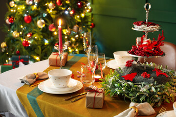 Dining table with beautiful setting in living room decorated for Christmas eve