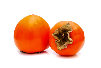 Two ripe persimmon fruits isolated on white background.