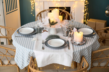 Dining table with beautiful setting in living room decorated for Christmas eve