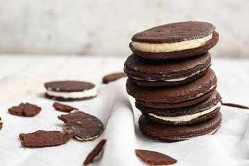 Tasty chocolate cookies with cream on table, closeup