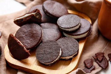 Board with sweet chocolate cookies on table, closeup