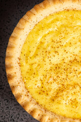 Delicious fresh baked custard tart sprinkled with ground nutmeg