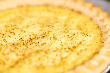 Delicious fresh baked custard tart sprinkled with ground nutmeg