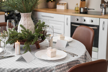 Dining table with beautiful setting for Christmas celebration and blank cards