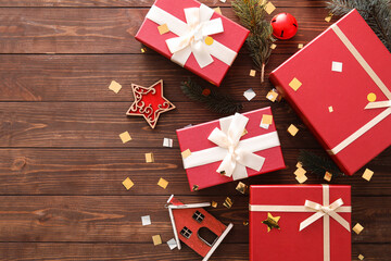 Fototapeta premium Beautiful composition with Christmas gift boxes, fir branches and decor on wooden background