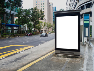 Vertical blank billboard ad mock up at a bus stop in the Central Business District of Singapore. © shurong