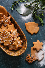 Basket with sweet Christmas gingerbread cookies on black background