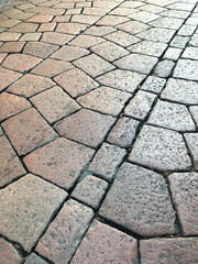 Fototapeta premium Ancient stone pavement design in Europe. イタリアの旧市街地の残る古い石畳の幾何学的文様。