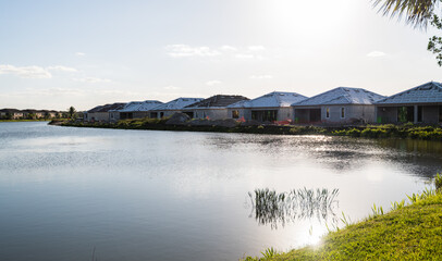 Fototapeta na wymiar Brand new real estate developments in a South Florida golf community, near the pond.