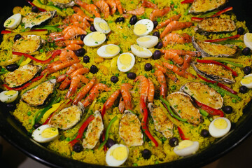 Seafood paella, with large shrimp, eggs, olives, rice and gratin oyster.