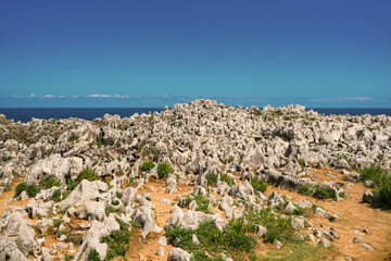 Rock formations and pebbles. Wave texture, a rock formation in the sea