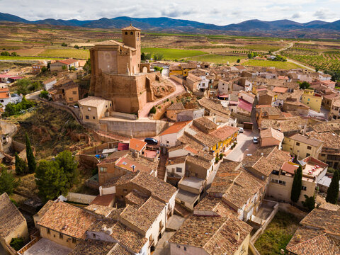 View from drone of Cervera de la Canada cityscape overlooking fortified Catholic church of Iglesia de Santa Tecla, Spain..