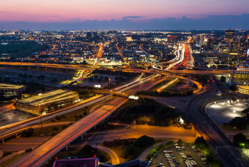 Beautiful view from above at the highway intersections and illuminated buildings in Dallas, Texas