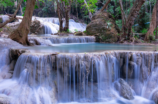 Erawan waterfalls in the national park mountains of Kanchanaburi BKK Bangkok Thailand lovely turquoise blue creamy waters lush green trees smooth rock formations © Elias Bitar