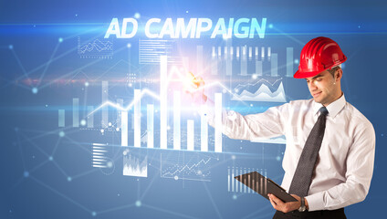 Young businessman with helmet drawing on virutal screen
