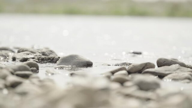 The art of stone illuminated by the light reflected on the surface of the flowing water