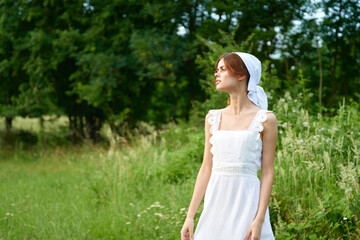 Naklejka na ściany i meble Woman in white dress countryside village nature ecology