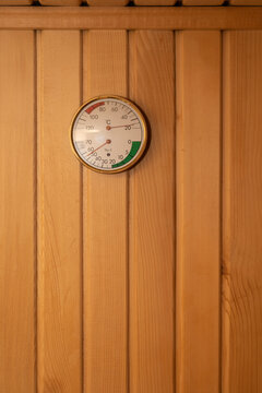 Sauna hygrometer with thermometer on a wooden sauna wall, copy space