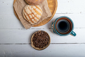 top view of traditional cup of Mexican coffee, coffee beans and sweet bread, shell type
